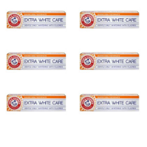 Arm & Hammer Extra White Care Toothpaste 125g tube on a clean bathroom shelf
